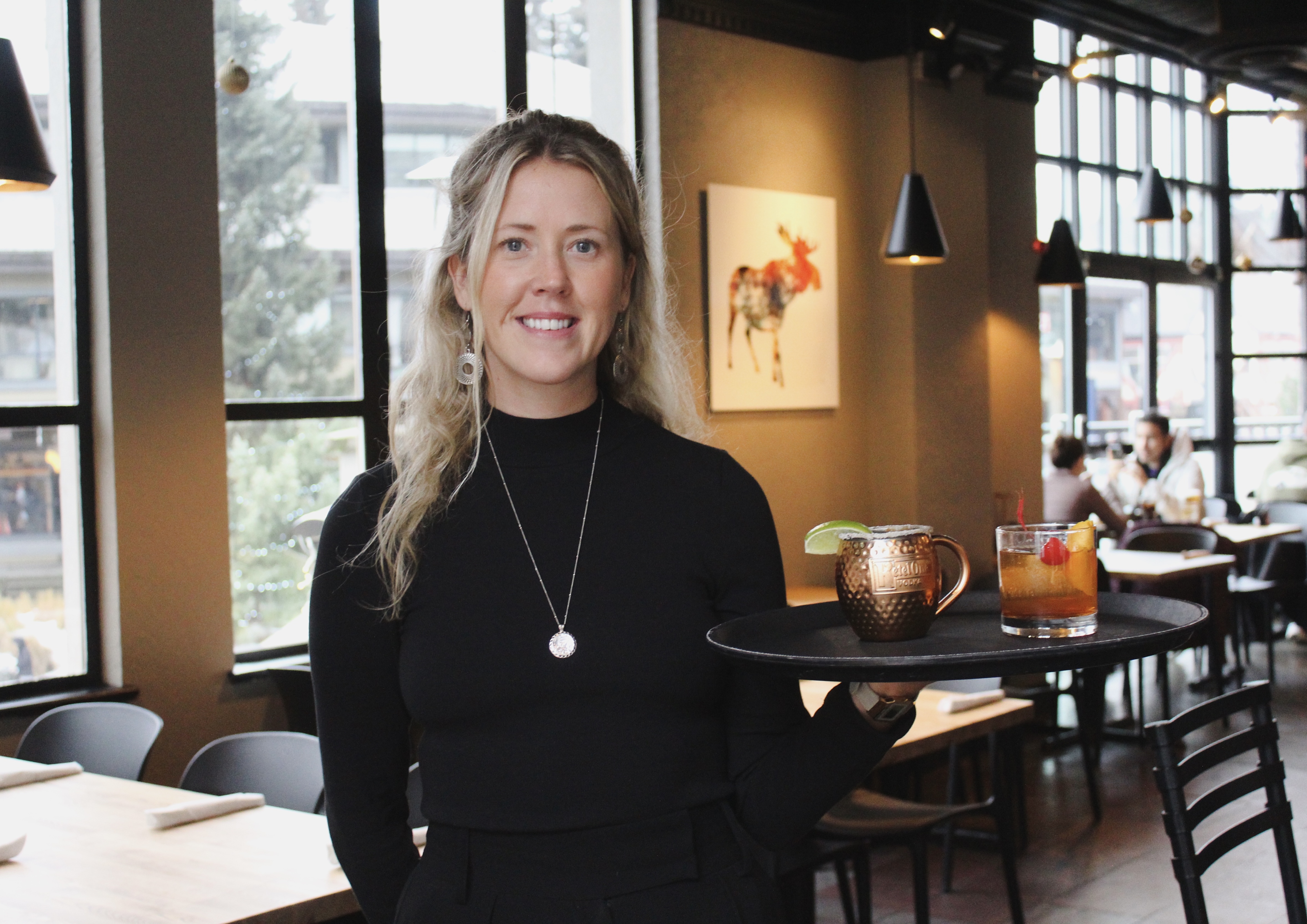 Server carrying cocktails through Mongolie Grill dining room