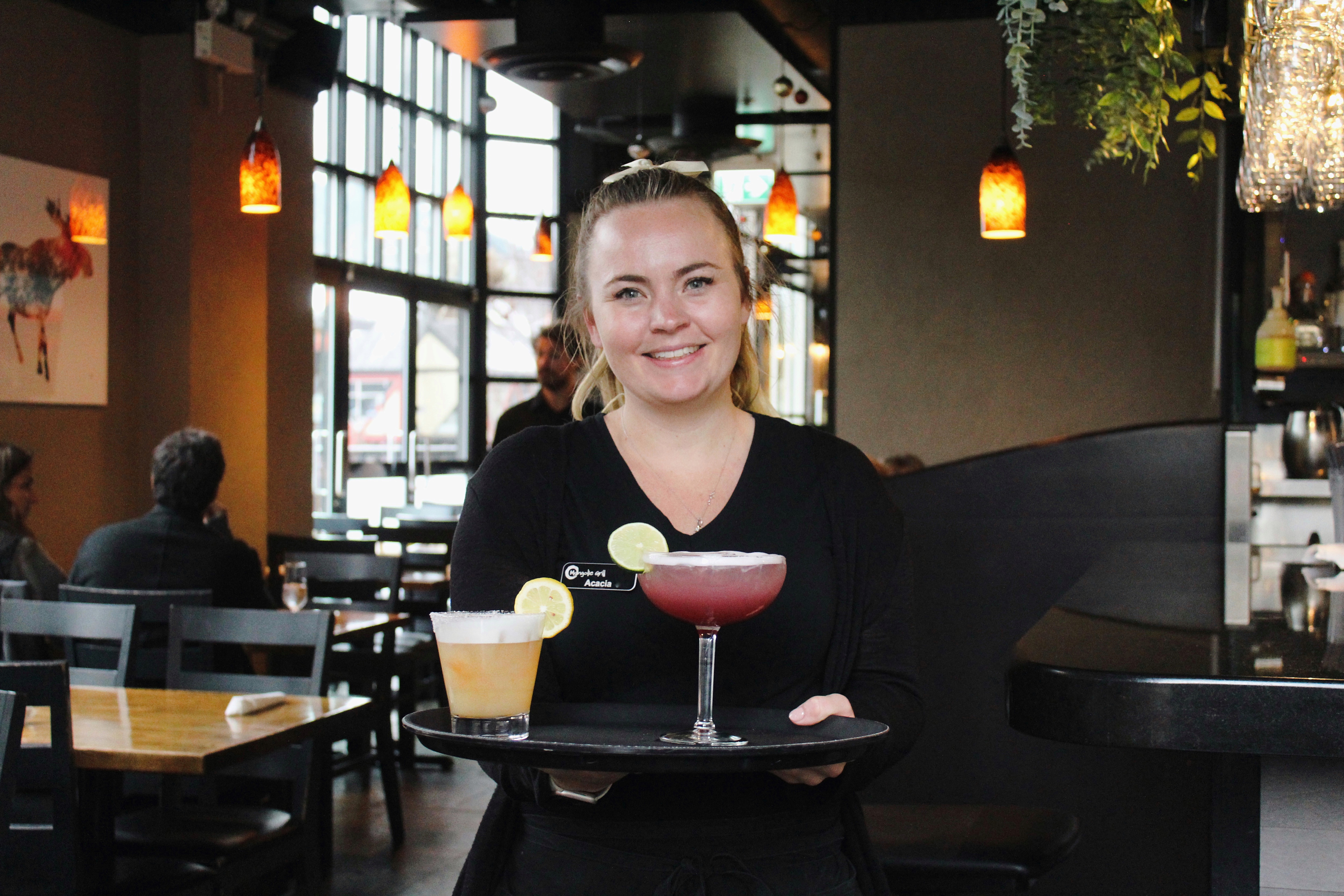 Server carrying cocktails through the Mongolie Grill dining room