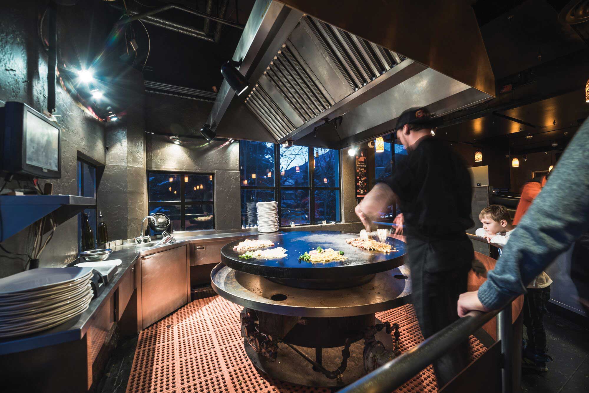 Chefs theatrically grill your stir-fry creation